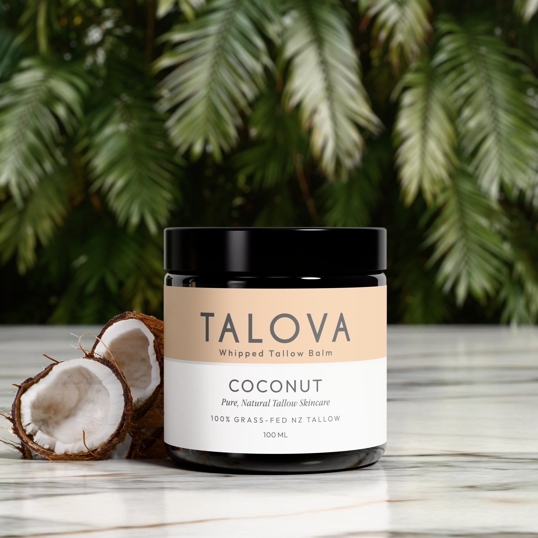 Talova whipped tallow balm jar with coconuts on a wooden surface with a green leafy background