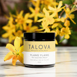 Talova Ylang Ylang whipped tallow balm jar with yellow flowers in the background